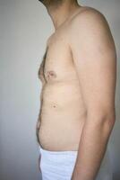 the side and stomach of a thirty-year-old man of average build photo