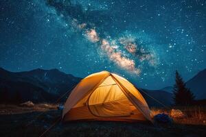 Illuminated tent under glowing night sky with stars and milky way. Tourist equipment for camping. photo