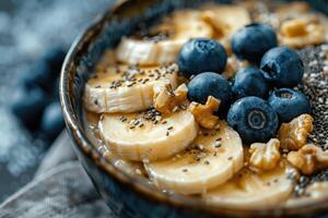 A nutritious breakfast serving of oatmeal with bananas, blueberries and chia seeds photo