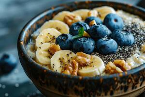 A nutritious breakfast serving of oatmeal with bananas, blueberries and chia seeds photo