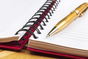 notebook and luxury pen close up with a blurred background photo