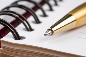 notebook and luxury pen close up with a blurred background photo