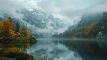 A tranquil autumn forest with a reflective lake and foggy mountains in the background creates a serene scene photo