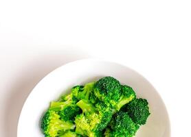Broccoli on a large white plate. Love for broccoli. photo