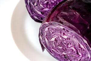 Red cabbage on a large white plate. Cut red cabbage on a white background. photo