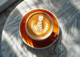 Top view of a orange cup of coffee with latte art on marble table at cafe generated by AI. photo