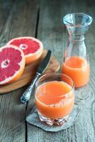 Grapefruit juice on the wooden table photo