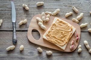 Sandwich with peanut butter on the wooden board photo
