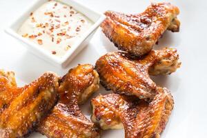 Baked chicken wings with spicy sauce photo