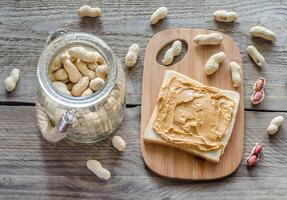 Sandwich with peanut butter on the wooden board photo