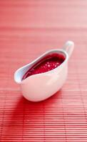 Sauce boat with red sauce photo