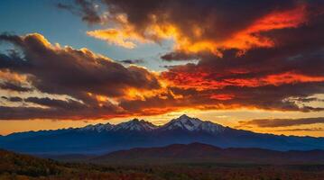 the mountain landscape is bathed in a kaleidoscope of colors, the sky shifting from vibrant oranges to deep purples, creating a stunning contrast against the darkening peaks. photo
