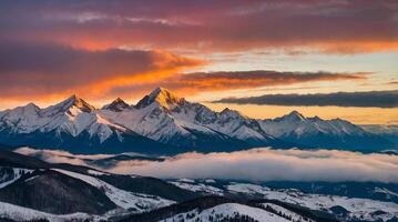 View of snowy mountains with colorful sunset in cloudy sky photo