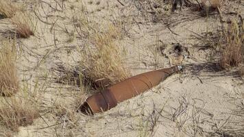 Unexploded ordnance in a field after hostilities. Dangerous find video
