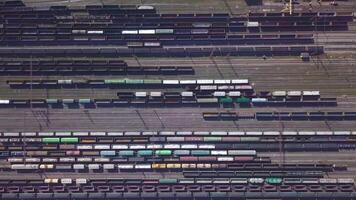 Aerial view of Railway sorting station and A lot of wagons at a railway. Drone flies over railway tracks. 4k quality video