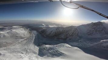 The plane flies over the Himalayan mountains. The tops of the mountains and the glacier are covered with snow. The area of the eight-thousandth Shishabangma. Tibet. video