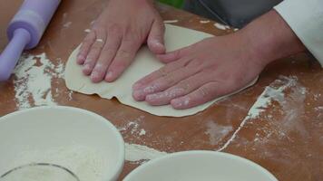 preparation of dough for dumplings , the cook rolls out the dough video