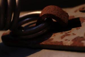 Rusty Metal Hook Holding Spring Ring. Sunshine Evening. Macro Closeup. photo