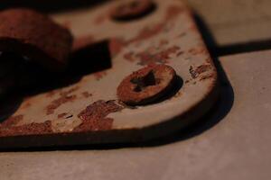 Rusty Screws on Weathered Painted Hook. Sunshine Evening. Macro Closeup. photo