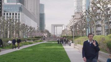 Paris, France - March 20, 2024 - The Esplanade du General de Gaulle emblematic place of La Defense and offers a breathtaking view of the famous towers of the EDF tower, the Total tower Grande Arche video
