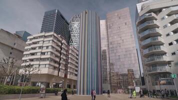 Paris, France - March 20, 2024 - The Moretti, also known as La Cheminee, is an iconic art installation in La Defense a colorful, cylindrical structure multicolored tubes video
