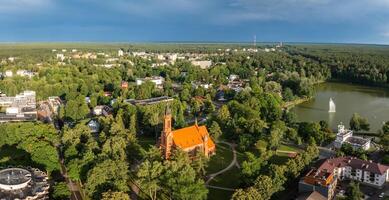 Aerial panoramic view of Lithuanian resort Druskininkai. Druskininkai in autumn colours, drone picture of multi coloured trees in most beautiful city of Druskininkai in Lithuania photo