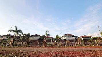 Zoom in timelapse panorama row of white residential buildings complex on sunny day time lapse with cloudscape movement.Copy space property in asia video