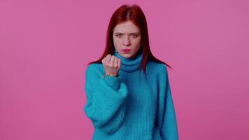 Aggressive angry girl trying to fight at camera, shaking fist, boxing with expression, punishment video