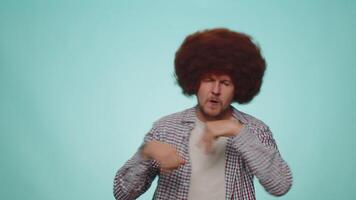 Funny man listening music, smiling dancing to disco partyrhythmically moving hands, having fun video