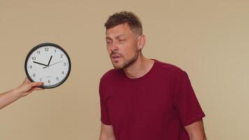 Man with anxiety checking time on clock, running late to work, being in delay, deadline video