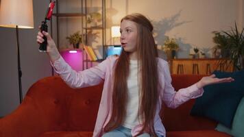 Child girl blogger taking selfie on smartphone communicating call home online with subscribers video