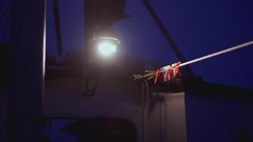 Boat lights. clip. Bright lights illuminate part of the boat. Part of a boat that has different things on it video