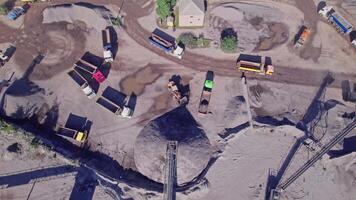 Excavator loading crushed stone into a dump truck in a crushed stone quarry video