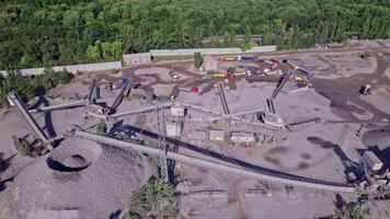 Excavator loading crushed stone into a dump truck in a crushed stone quarry video
