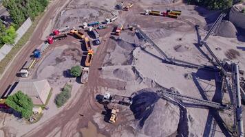 Excavator loading crushed stone into a dump truck in a crushed stone quarry video