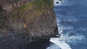 Aerial view of the Rynisfjara black sand beach in Iceland. Black sand beach and Reynisdrangar stack rocks of Vik i myrdal, Iceland. Famous basalt rocks on black sand beach near Vik video
