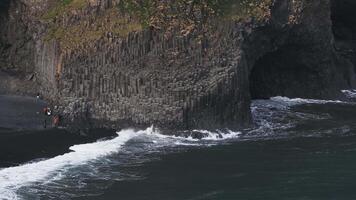 Aerial view of the Rynisfjara black sand beach in Iceland. Black sand beach and Reynisdrangar stack rocks of Vik i myrdal, Iceland. Famous basalt rocks on black sand beach near Vik video