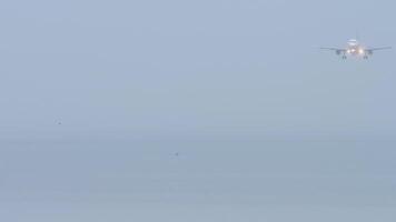 Passenger plane flies in foggy and rainy weather, poor visibility. Unrecognizable airliner descending for landing video