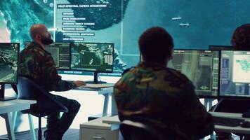 Group of soldiers managing air and sea traffic control for military operations success, working together in federal command post. National surveillance systems using satellite radar. Camera A. video