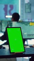 Vertical Isolated greenscreen display running on a tablet in military power base, soldiers follow surveillance footage to stay alert in case of a hostile attack. Satellite system for reconnaissance. Camera A. video