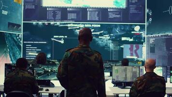 General headquarters under ruling of army IT professional that reviews insight about a new national safety mission. Command sergeant major briefing his marine corps troops with big data. Camera B. video