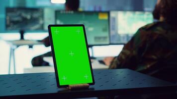 General headquarters monitoring room with a mockup screen on tablet, army officers safeguarding the coast line from enemy vessels. National guard machinists in control center. Camera A. video