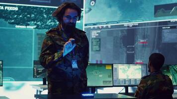 Infantry unit leader studies satellite imagery on a holographic image, working with high tech holograms to create the mission details for the troops. Ways to attack hostile vessels at sea. Camera A. video