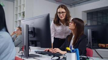 Two Women Office Workers Discussing New Project, Ladies Looking At Computer Display video