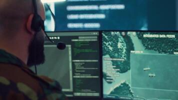 Military operator transmitting gps coordinates of hostile ships to national guard, providing real time data from surveillance CCTV system. Army officer works in power base control center. Camera A. video