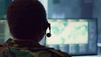 Woman military personnel tracking enemy vessels on the coast line territory, working on national safety and providing real time data to the dispatch center. Reconnaissance system. Camera A. video