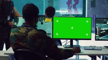 Control room operator tracking all ships anchoring along the coast line, uses isolated chromakey display in command post. Military personnel helps with real time information, reconnaissance. Camera A. video