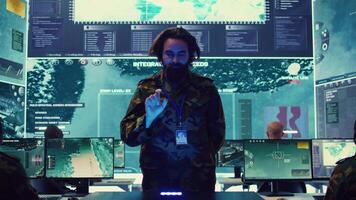 Infantry unit leader studies satellite imagery on a holographic image, working with high tech holograms to create the mission details for the troops. Ways to attack hostile vessels at sea. Camera B. video