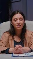 Pov of exhausted businesswoman talking with remote business team discussing marketing project deadline during online videocall conference meeting. Tired entrepreneur working in startup company office video