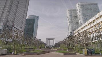 Paris, France - March 20, 2024 - The Esplanade du General de Gaulle emblematic place of La Defense and offers a breathtaking view of the famous towers of the EDF tower, the Total tower Grande Arche video